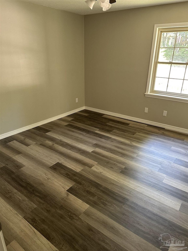 5303 Mikes Pl, Milton, FL 32570 - spare room with dark wood-type flooring, baseboards, and ceiling fan