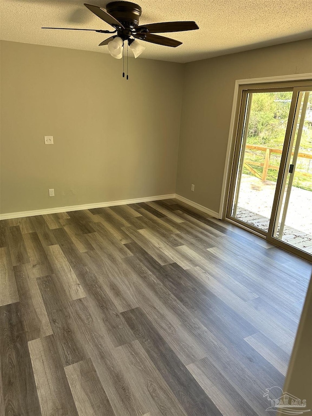 5303 Mikes Pl, Milton, FL 32570 - spare room with dark wood-type flooring, a textured ceiling, baseboards, and a ceiling fan