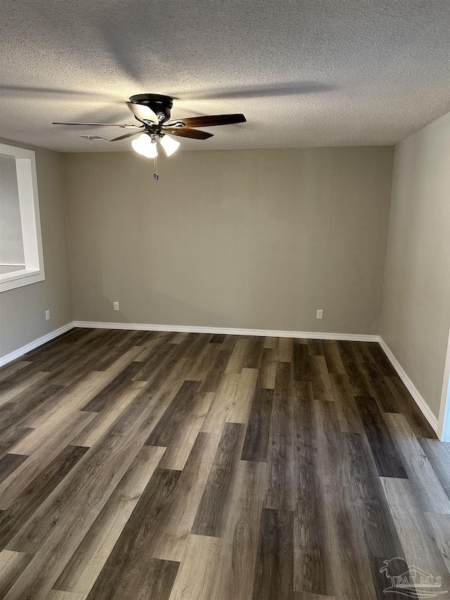 5303 Mikes Pl, Milton, FL 32570 - empty room with a textured ceiling, ceiling fan, baseboards, and dark wood-style floors