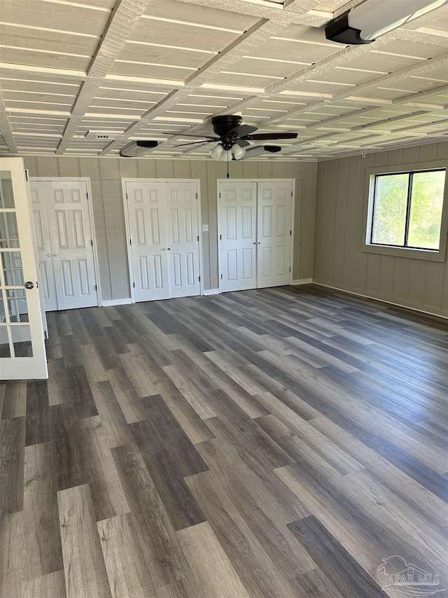 5303 Mikes Pl, Milton, FL 32570 - unfurnished bedroom with dark wood-style flooring, ceiling fan, and multiple closets