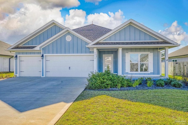 craftsman house with a front yard and a garage