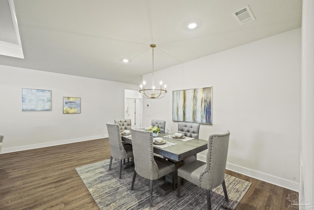 dining space featuring a notable chandelier and dark hardwood / wood-style flooring