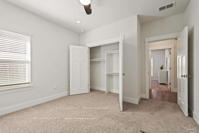 unfurnished bedroom with a closet, ceiling fan, and carpet