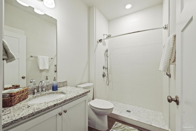 bathroom featuring a shower, toilet, and vanity