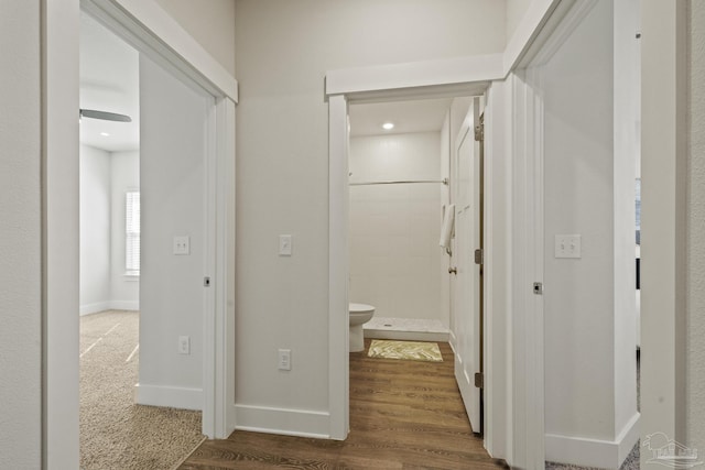 corridor with hardwood / wood-style floors