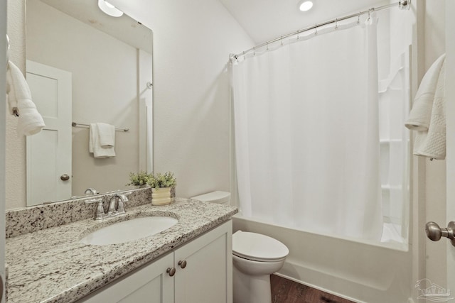 full bathroom with hardwood / wood-style flooring, toilet, vanity, and shower / bath combo with shower curtain