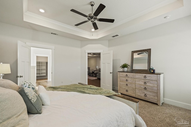 bedroom featuring a closet, ceiling fan, a spacious closet, and a tray ceiling