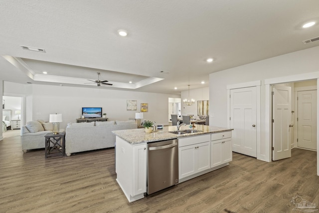 kitchen with white cabinetry, stainless steel dishwasher, a raised ceiling, and a kitchen island with sink