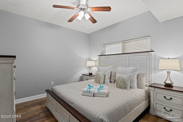 bedroom featuring ceiling fan, baseboards, and dark wood-style flooring