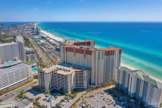 drone / aerial view with a beach view, a city view, and a water view