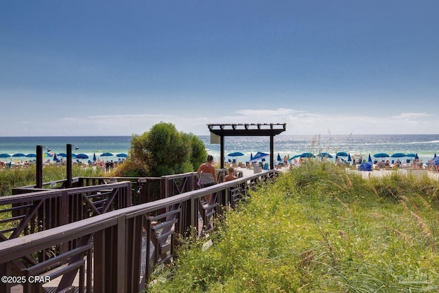 view of home's community with a beach view and a water view