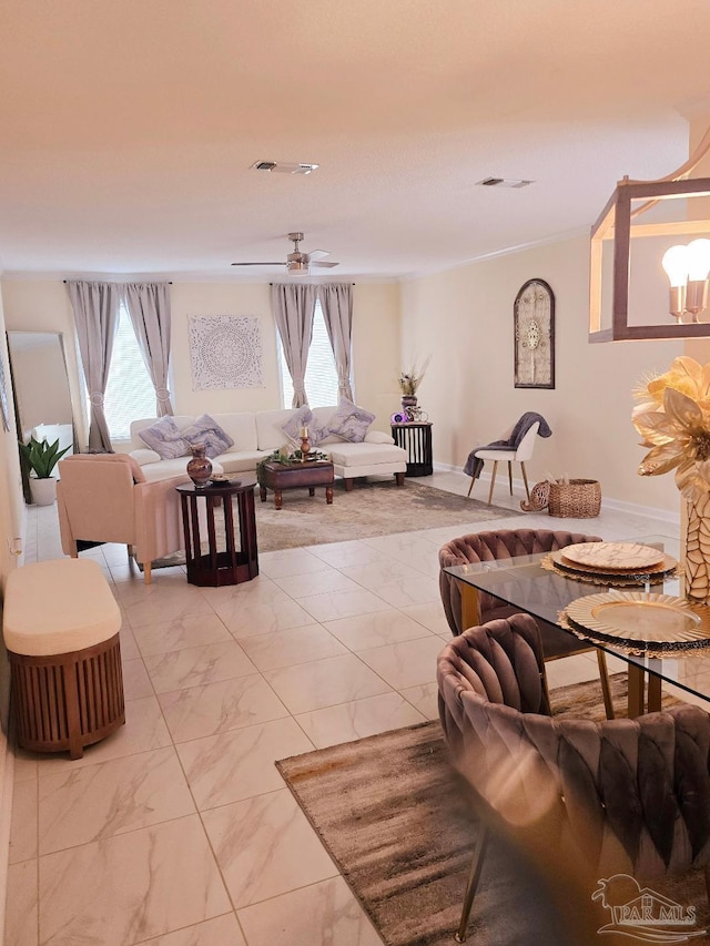 living area featuring marble finish floor, plenty of natural light, and visible vents