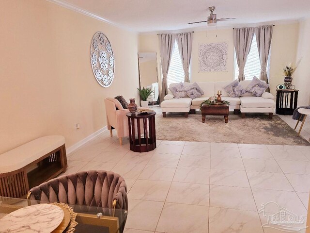 living room with ornamental molding, a wealth of natural light, ceiling fan, and baseboards