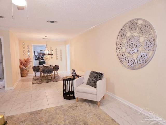 living area featuring baseboards, visible vents, a chandelier, and ornamental molding