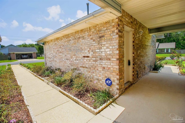 view of side of property featuring brick siding