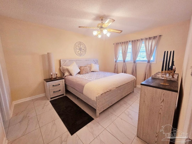 bedroom with marble finish floor, ceiling fan, baseboards, and a textured ceiling