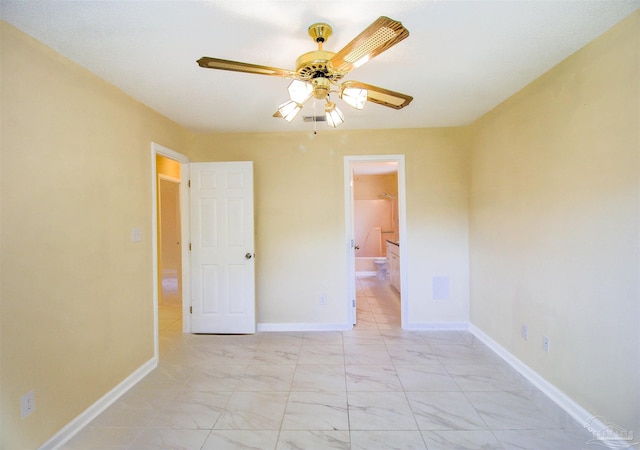 unfurnished bedroom with marble finish floor, ceiling fan, baseboards, and ensuite bathroom