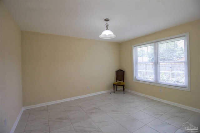 unfurnished room with baseboards