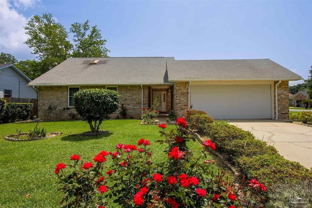 ranch-style home with an attached garage, a front lawn, concrete driveway, and brick siding