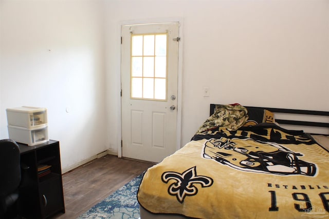 bedroom featuring dark wood finished floors and baseboards