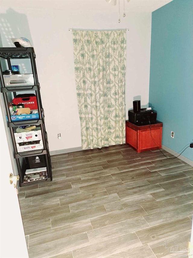 interior space featuring wood finish floors and baseboards