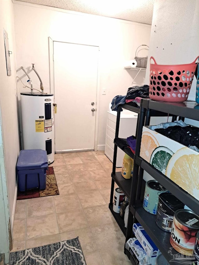 interior space with light tile patterned floors and electric water heater