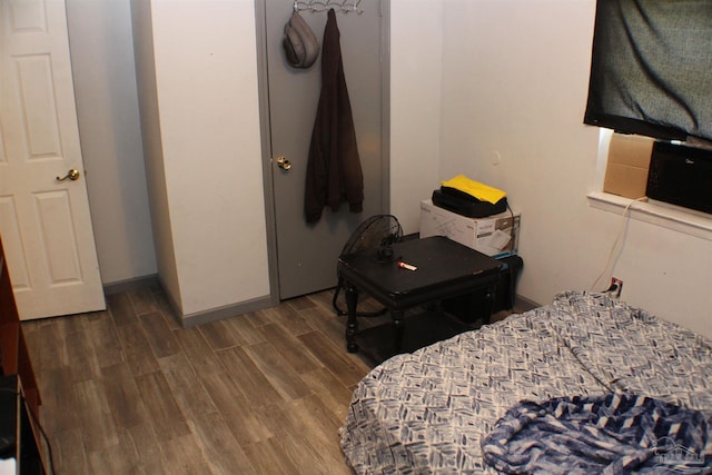 bedroom with dark wood-type flooring