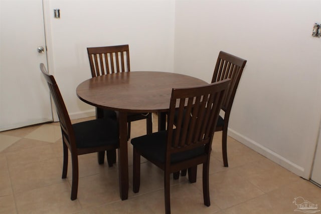 dining area with light tile patterned flooring and baseboards