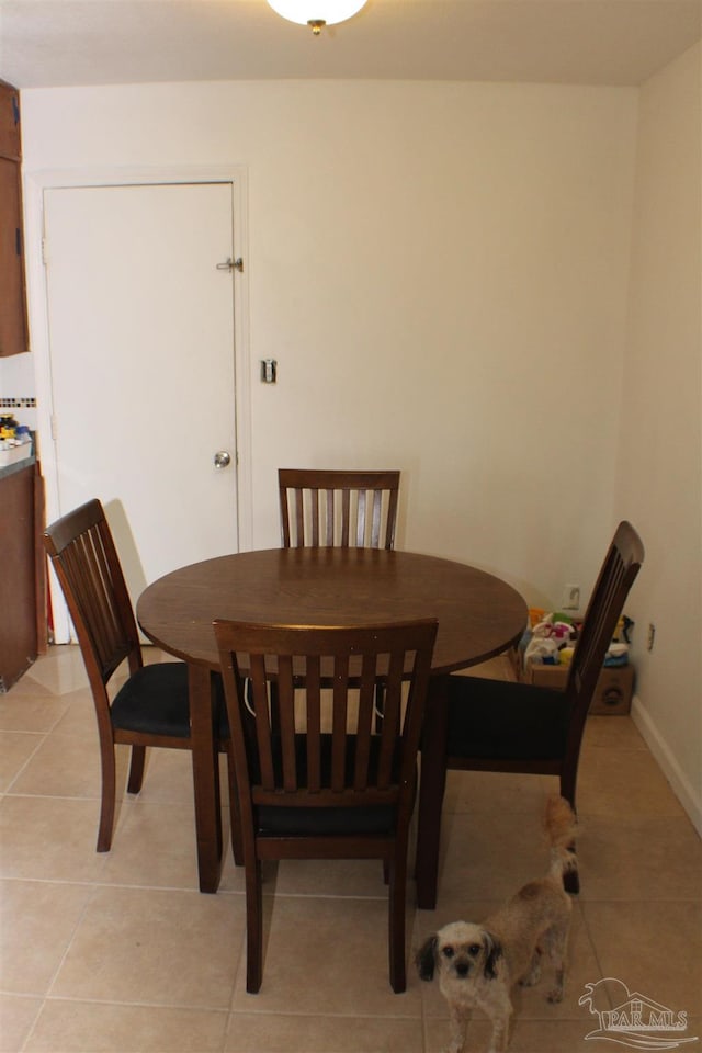 dining area with light tile patterned floors