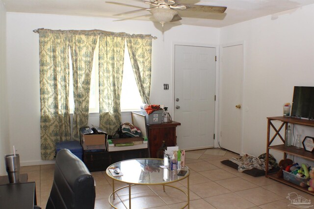 interior space featuring ceiling fan and light tile patterned floors