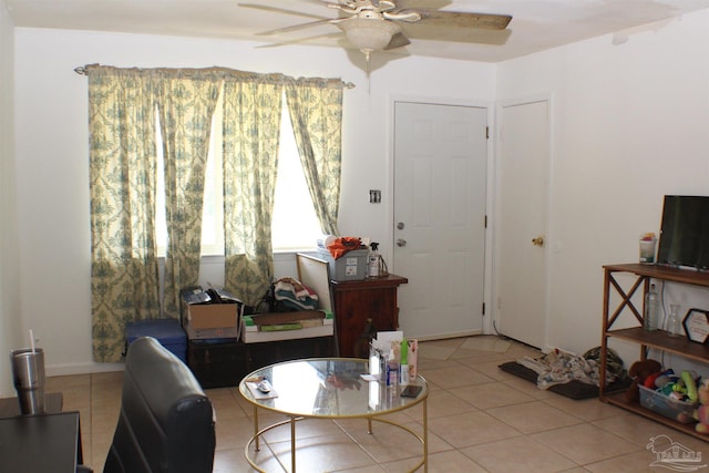 living room featuring light tile patterned floors and ceiling fan