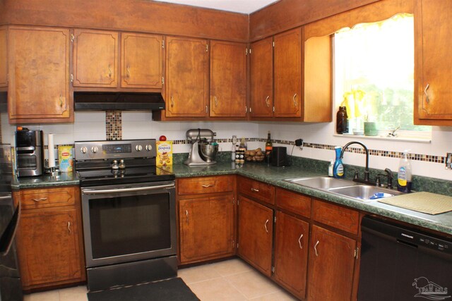 kitchen featuring appliances with stainless steel finishes, light tile patterned floors, and sink