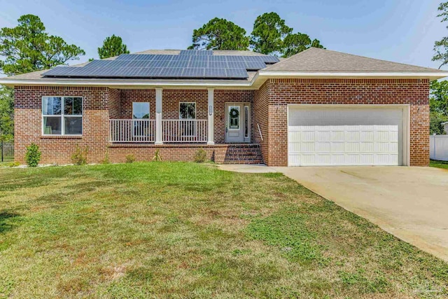 ranch-style home with a front yard, solar panels, and a garage