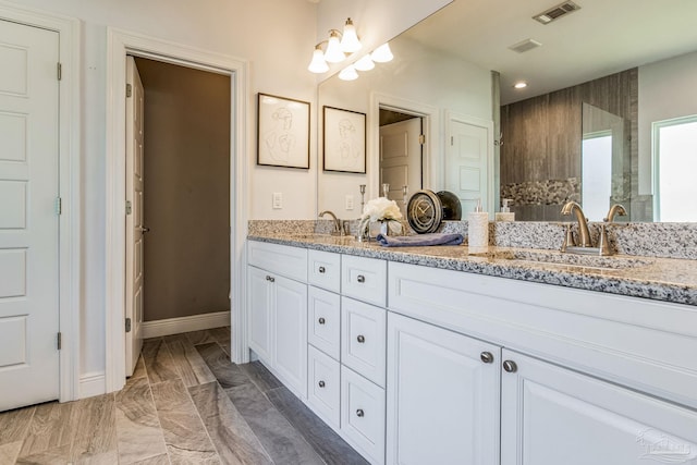 bathroom featuring tile patterned flooring and vanity