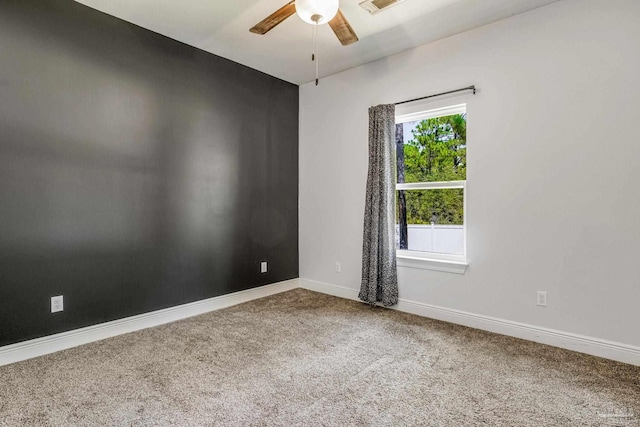 spare room with carpet and ceiling fan