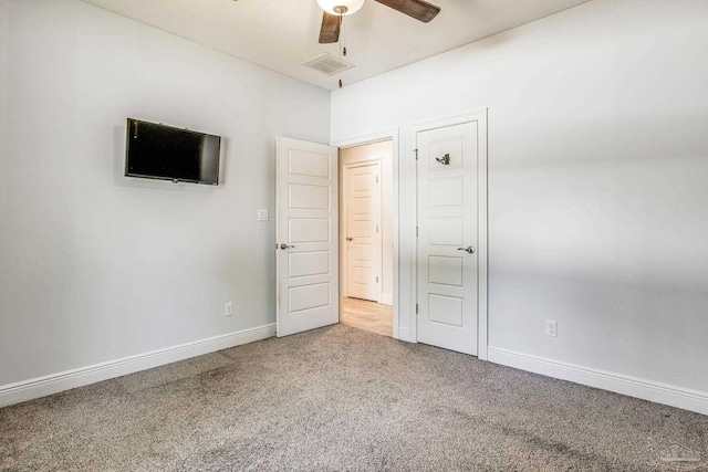 unfurnished bedroom with ceiling fan and light carpet