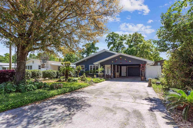 ranch-style house featuring a carport and concrete driveway