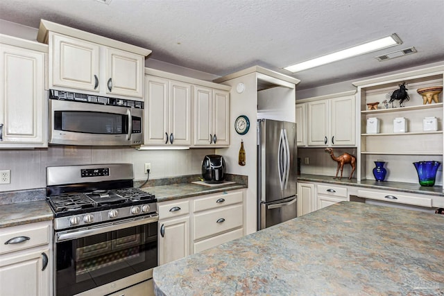 kitchen with appliances with stainless steel finishes and a textured ceiling