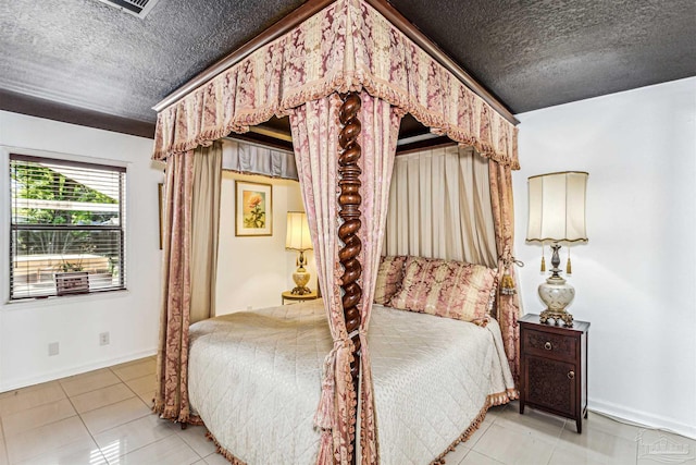 bedroom with a textured ceiling and light tile patterned floors