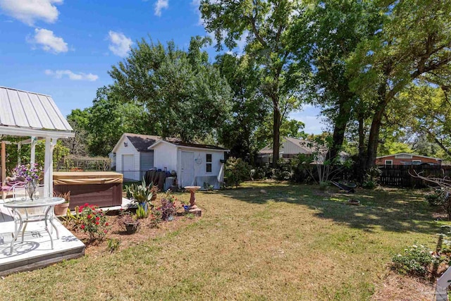 view of yard featuring a hot tub and a shed