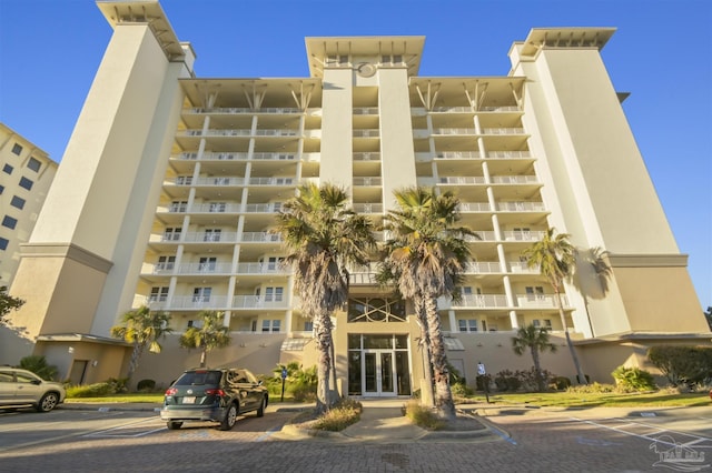 view of building exterior with uncovered parking