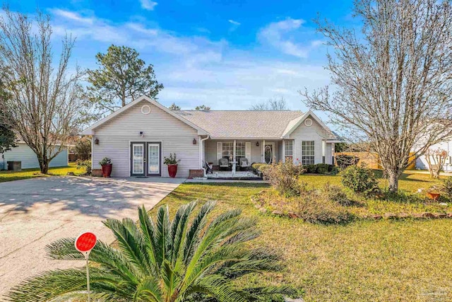 single story home featuring french doors and a front lawn