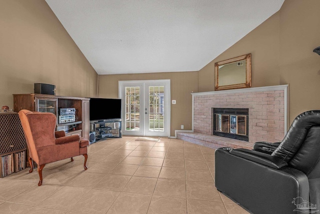 living room featuring french doors, a fireplace, light tile patterned floors, and vaulted ceiling