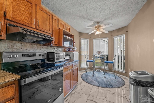 kitchen featuring ceiling fan, stone counters, electric stove, and backsplash