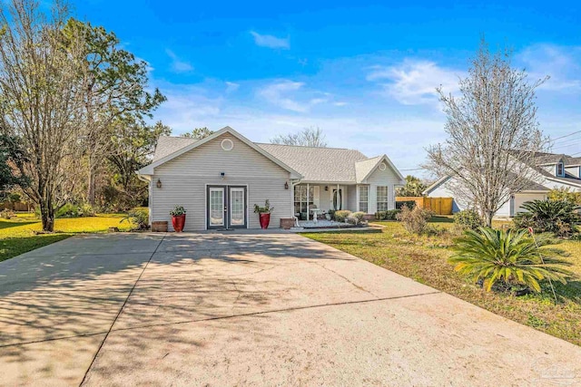 single story home with french doors and a front yard