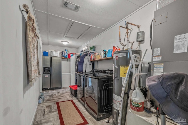 utility room featuring washer and dryer and electric water heater