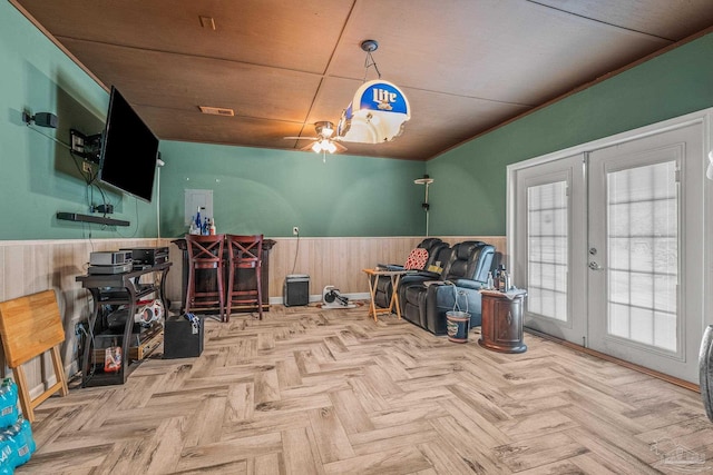 miscellaneous room featuring light parquet flooring, wood walls, french doors, ceiling fan, and wooden ceiling