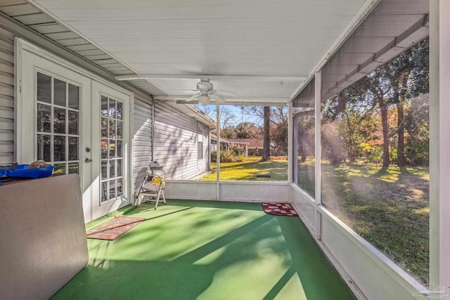 unfurnished sunroom with ceiling fan