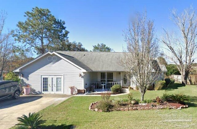 rear view of property featuring a porch, french doors, and a yard