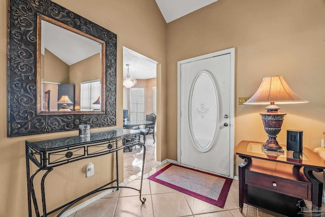 foyer entrance featuring light tile patterned floors and a notable chandelier